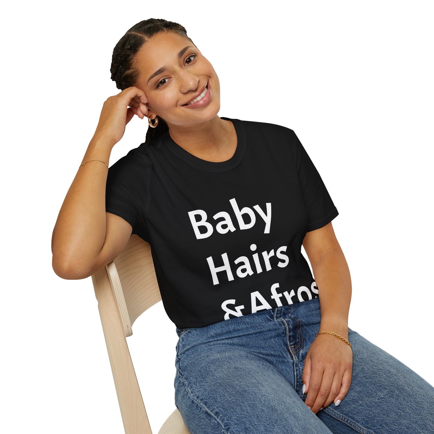 Young girl sitting in a chair wearing a Black T shirt with words "Baby Hairs and Afros " 