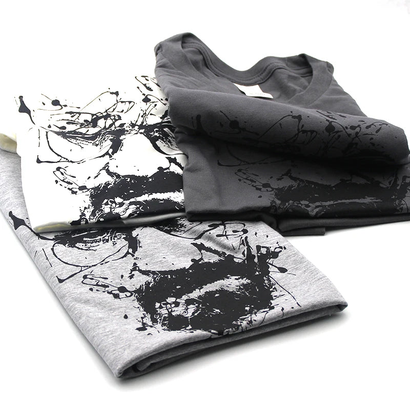 White and grey t-shirts with an ink splatter image of Walter White AKAHeisenberg
