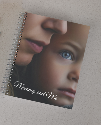 Spiral notebook with a picture of a mother's face close to her daughter's. The words "Mommy and me" at the bottom.. 