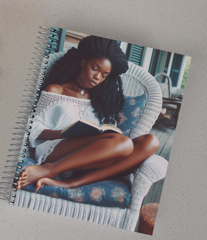 Spiral notebook with a beautiful woman sitting in a wicker chair reading a book.