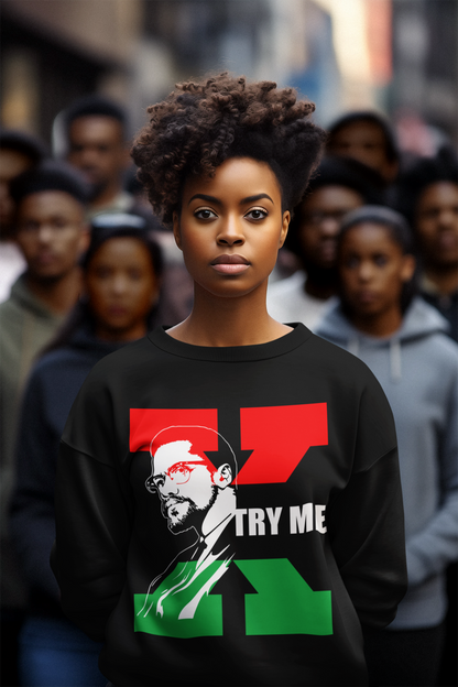 African American Woman with a Black sweatshirt. On the Hoodie is a sketch of Malcolm X with a Red and Green X behind him and the words "Try Me' next to him in white letters.