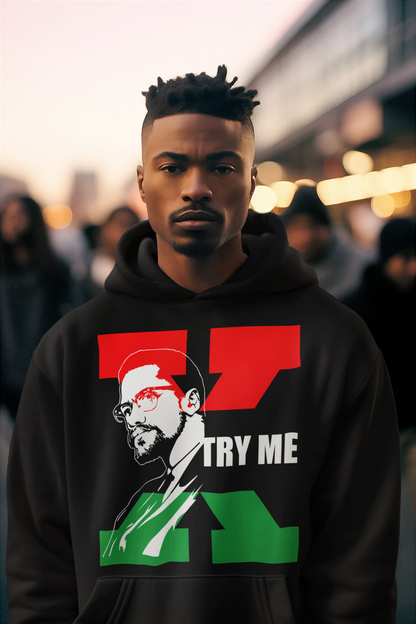 African American Man with a Black Hoodie. On the Hoodie is a sketch of Malcolm X with a Red and Green X behind him and the words "Try Me' next to him in white letters.