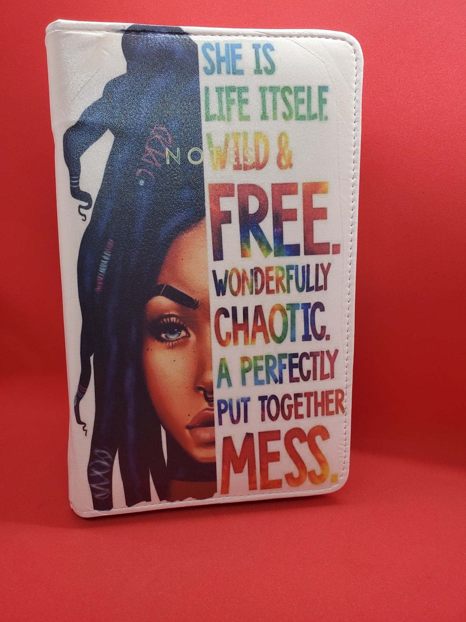 White Leatherette Journal with a Woman on one Half and the other half, the words "She is Life it'self Wild  &Free. Wonderfully Chaotic. A perfectly put together Mess.