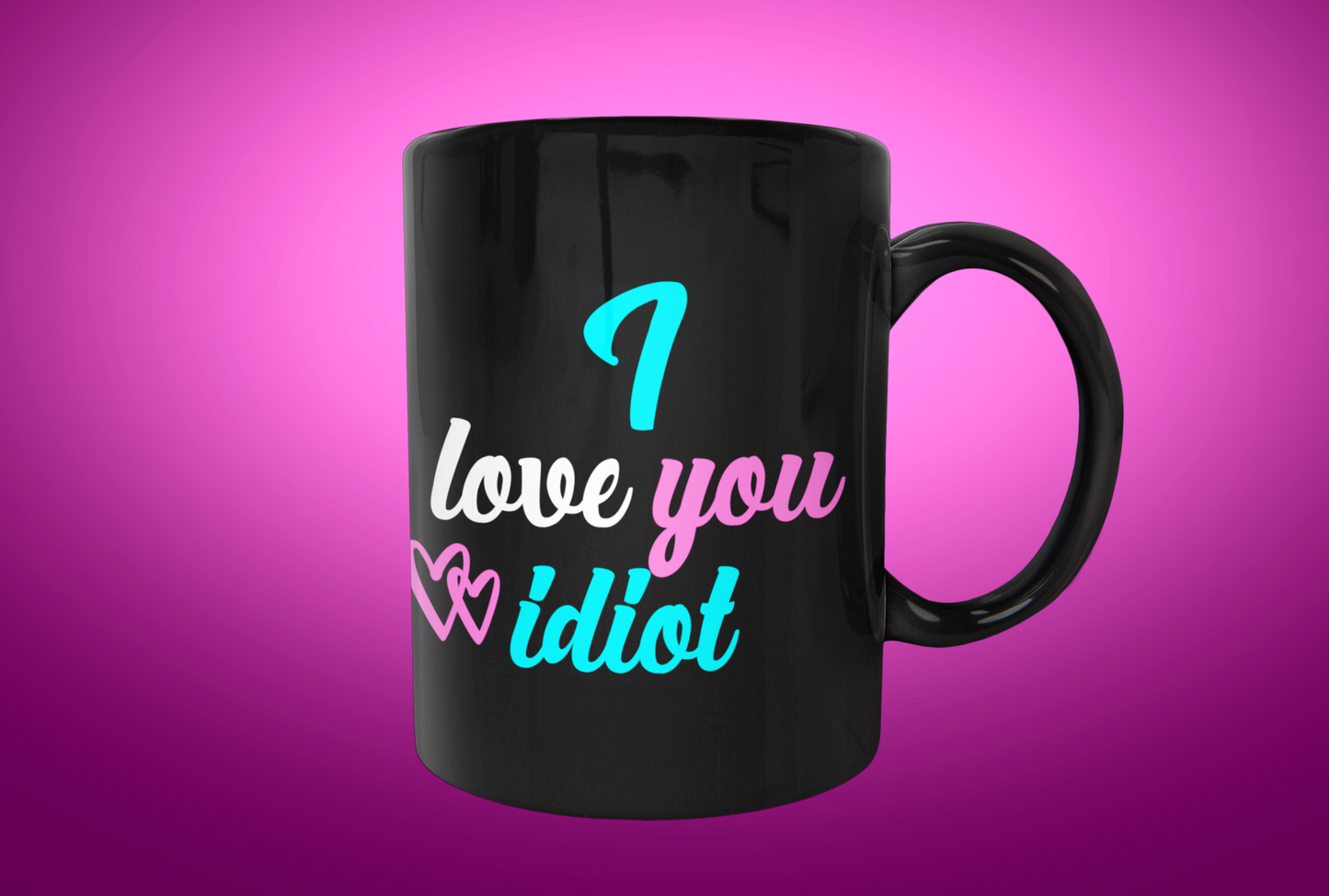 Black mug that says "I love you idiot" in blue white and pink characters.