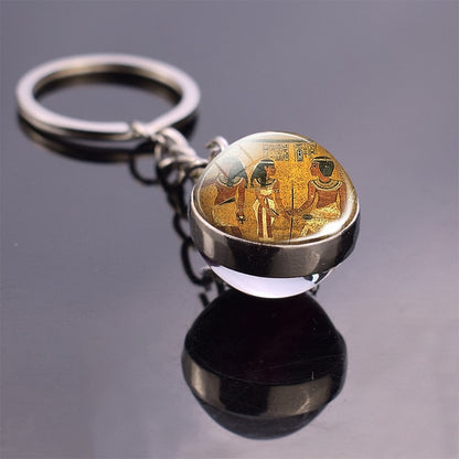 Glass ball keychain with Egyptian art.