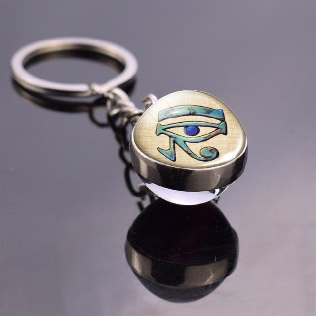Glass ball keychain with Egyptian art. The Eye
